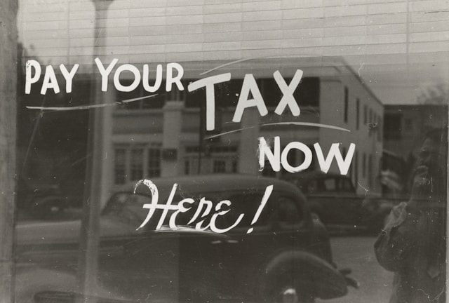 Window with pay your tax here written on it.
